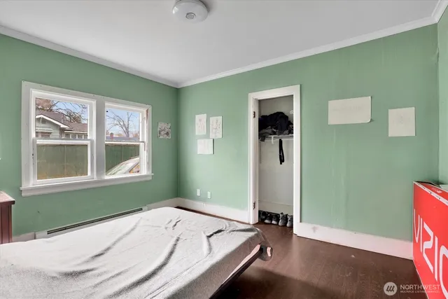 a bedroom with a bed and a window