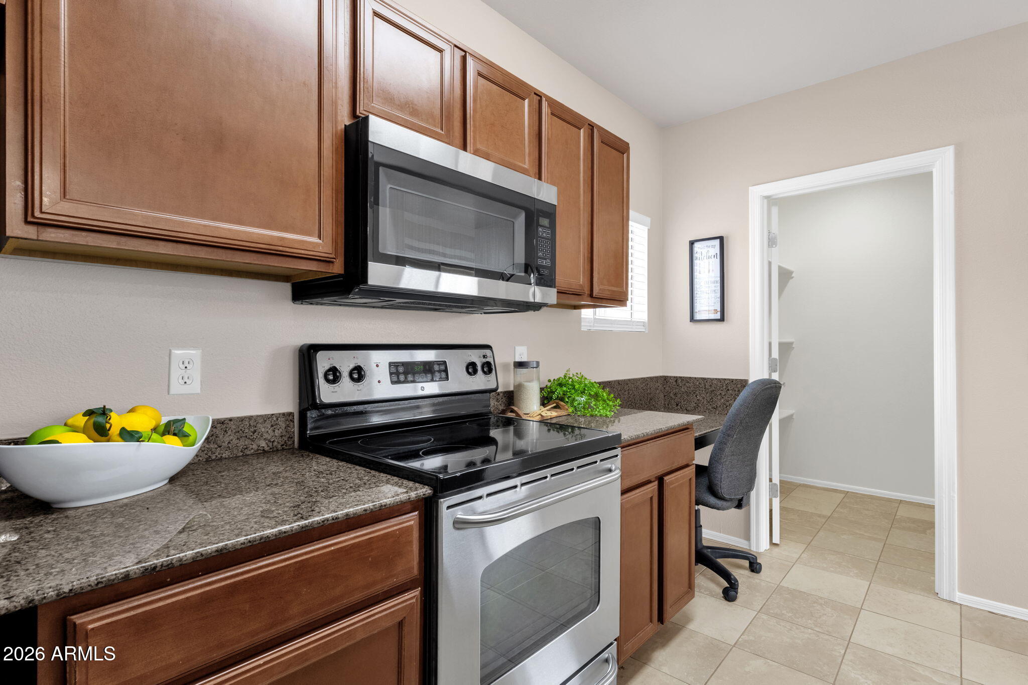 2134 East Broadway Road, Unit 2010 Tempe, AZ 85282 - Photo 11 of 42 a kitchen with stainless steel appliances granite countertop a stove and a microwave