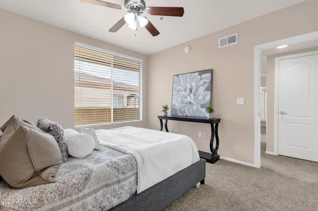 a bedroom with a bed and window