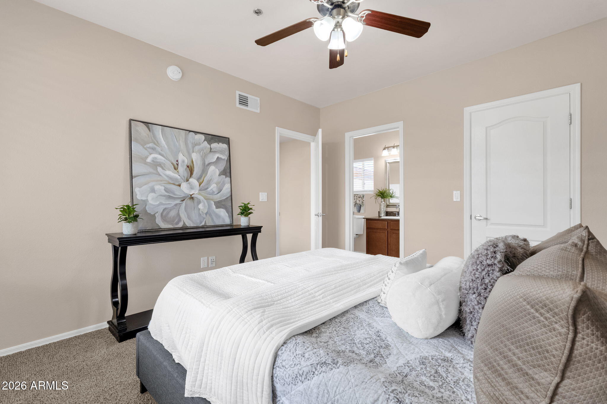 2134 East Broadway Road, Unit 2010 Tempe, AZ 85282 - Photo 17 of 42 a bedroom with a bed and painting on the wall