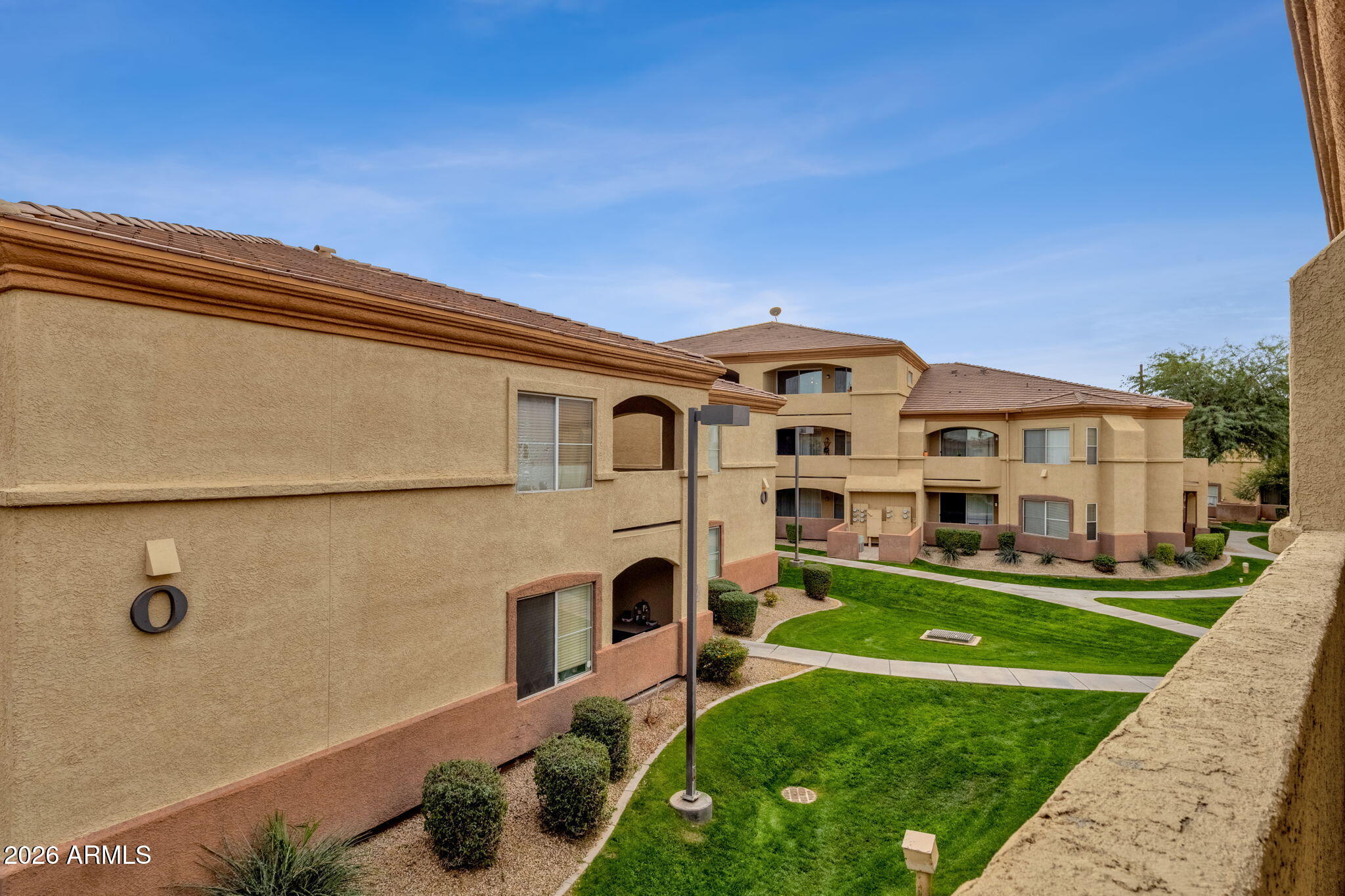 2134 East Broadway Road, Unit 2010 Tempe, AZ 85282 - Photo 26 of 42 a front view of a house with a garden
