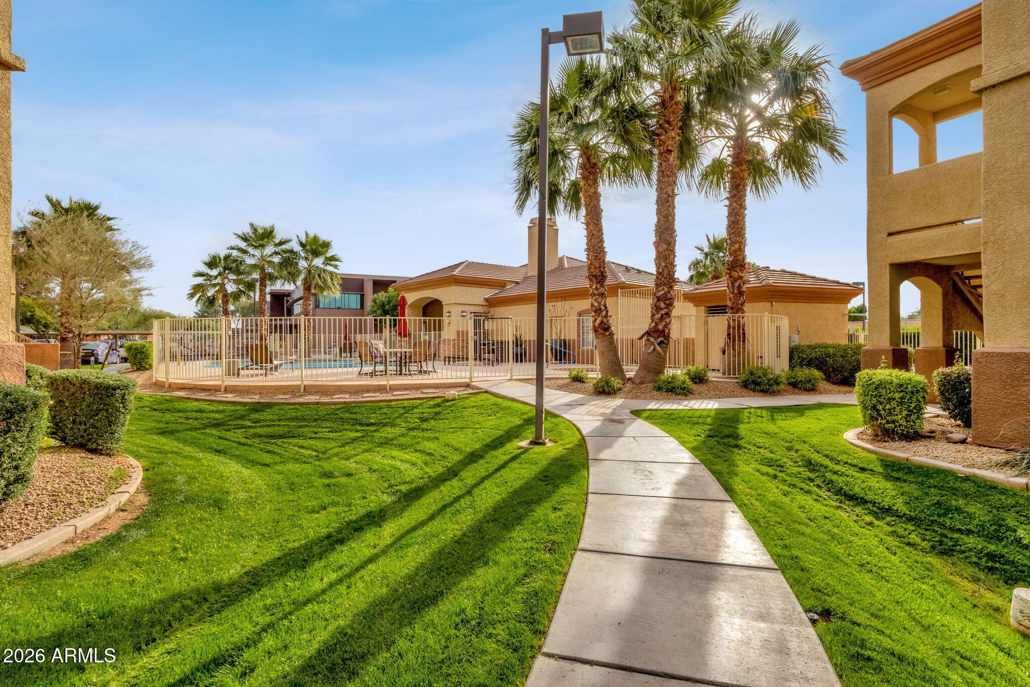 2134 East Broadway Road, Unit 2010 Tempe, AZ 85282 - Photo 28 of 42 a view of a swimming pool with a garden