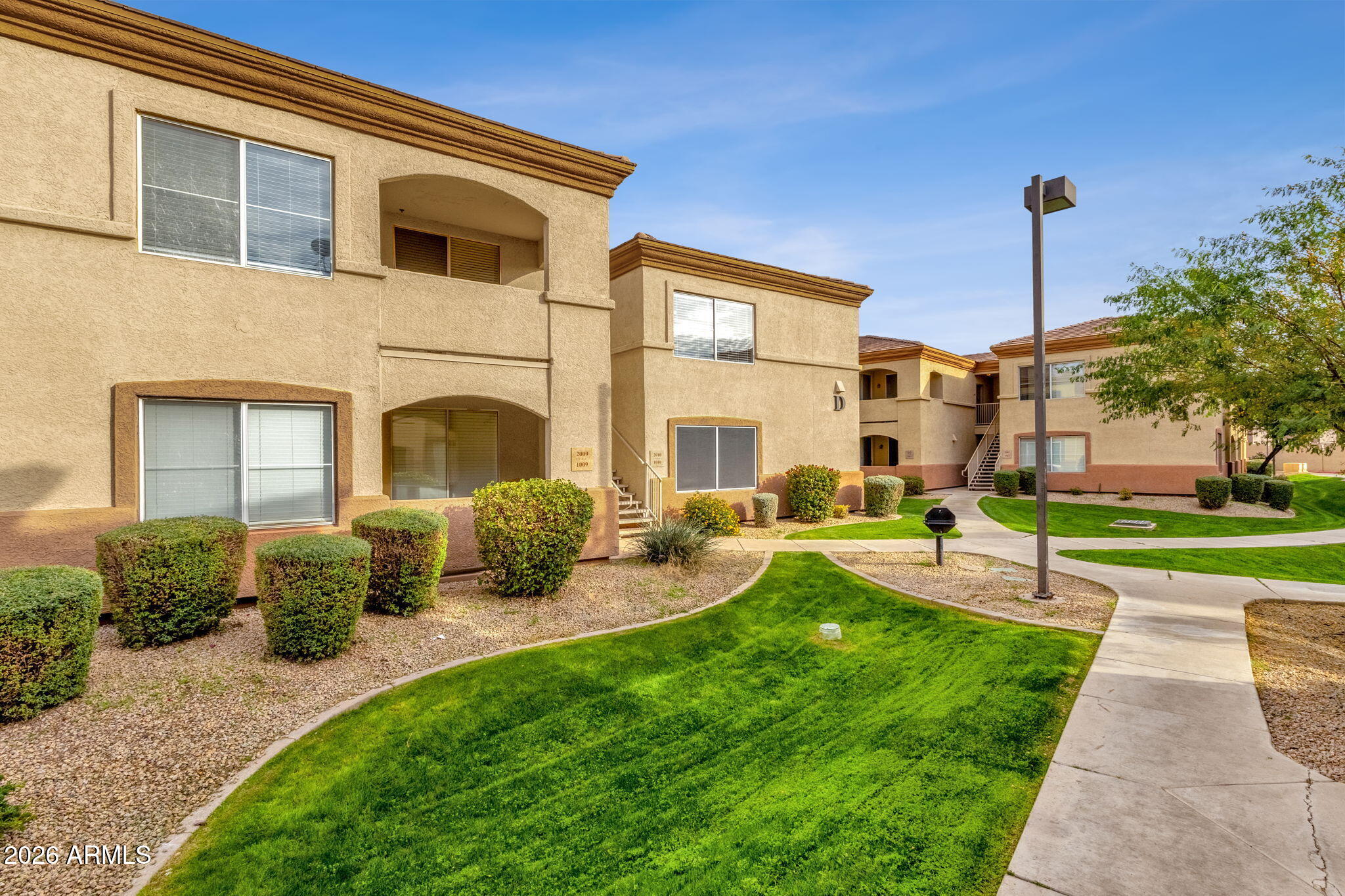 2134 East Broadway Road, Unit 2010 Tempe, AZ 85282 - Photo 2 of 42 a view of a house with backyard sitting area and garden