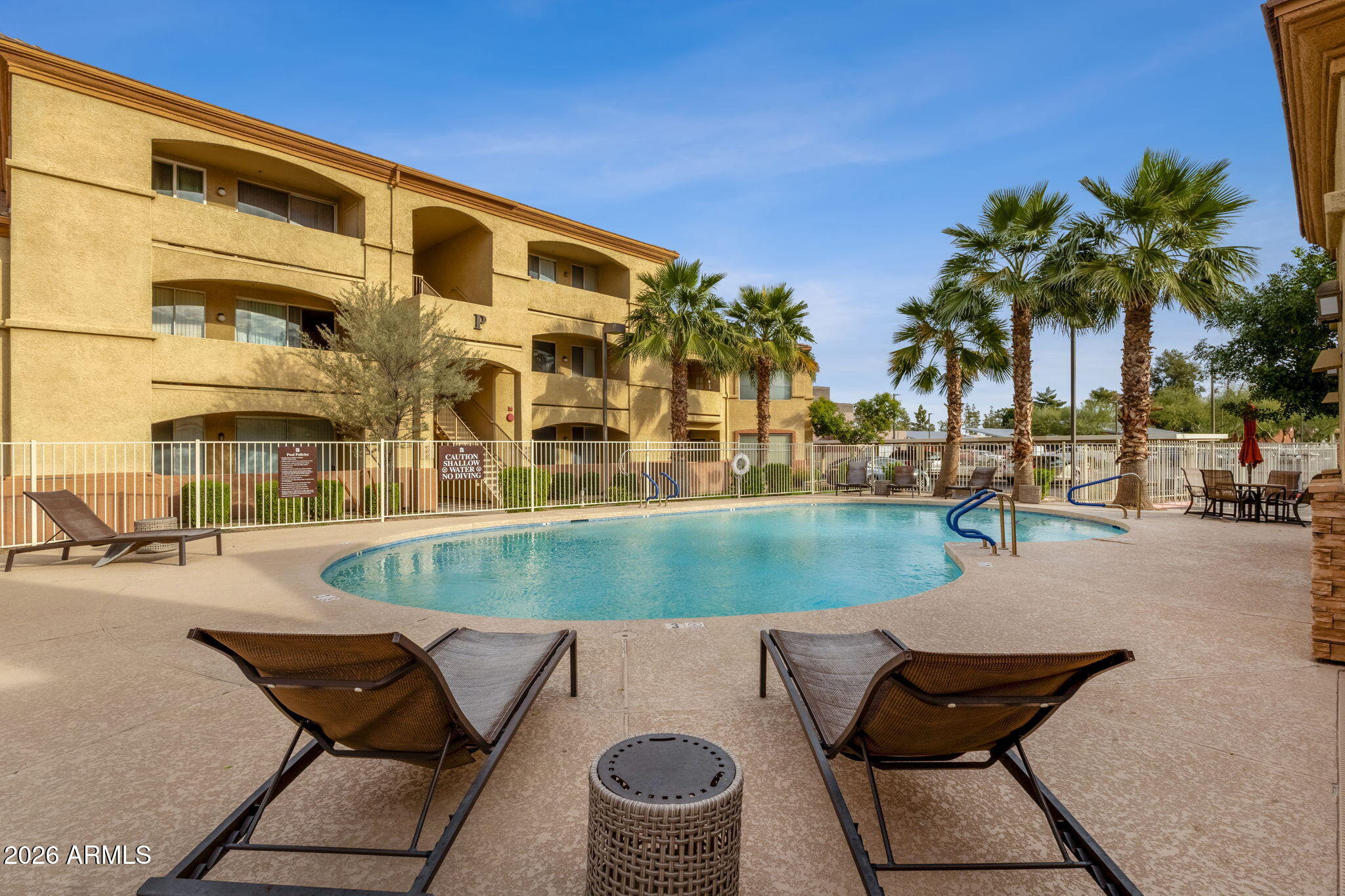 2134 East Broadway Road, Unit 2010 Tempe, AZ 85282 - Photo 30 of 42 a view of a swimming pool with a lounge chairs