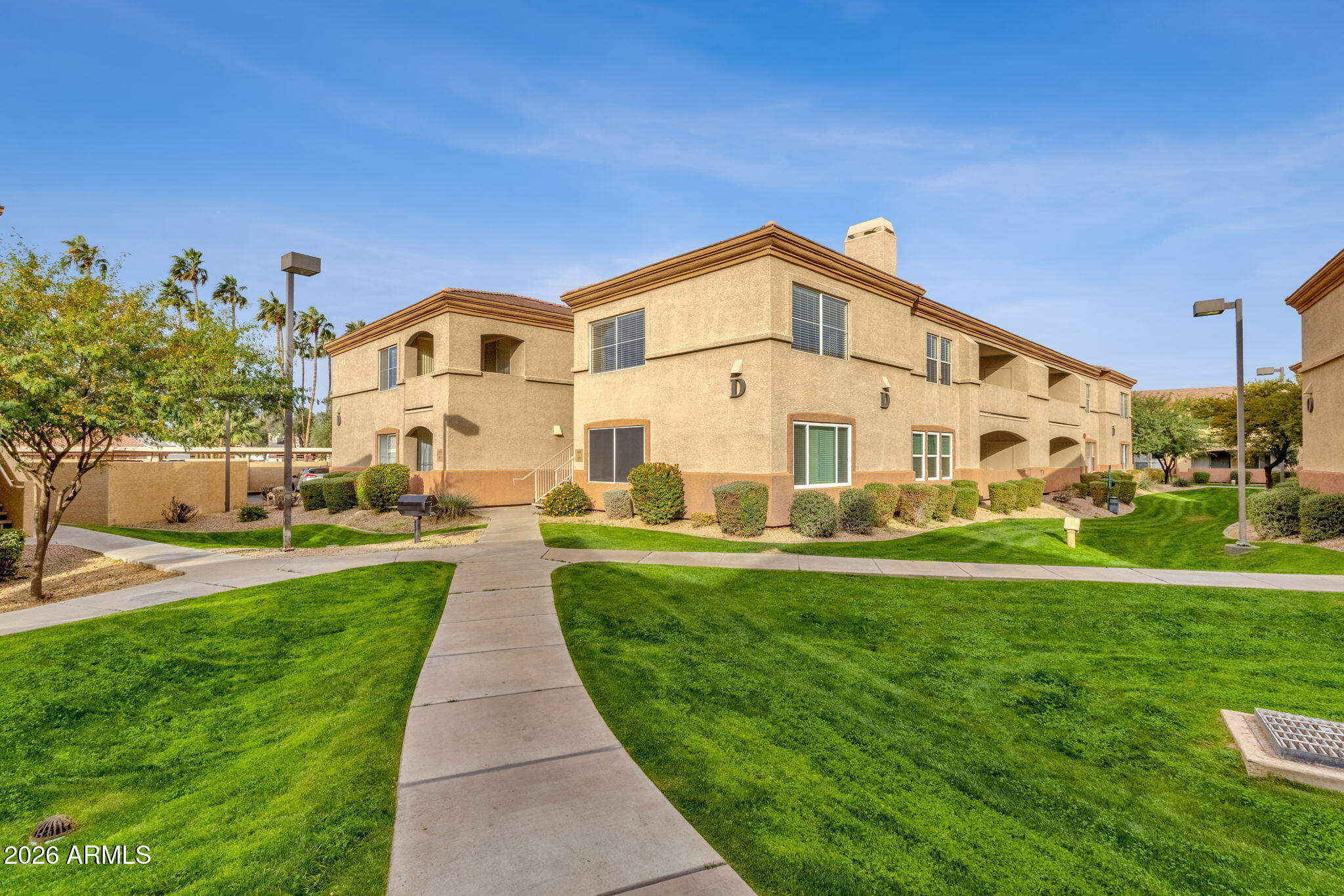 2134 East Broadway Road, Unit 2010 Tempe, AZ 85282 - Photo 34 of 42 a front view of a house with a yard