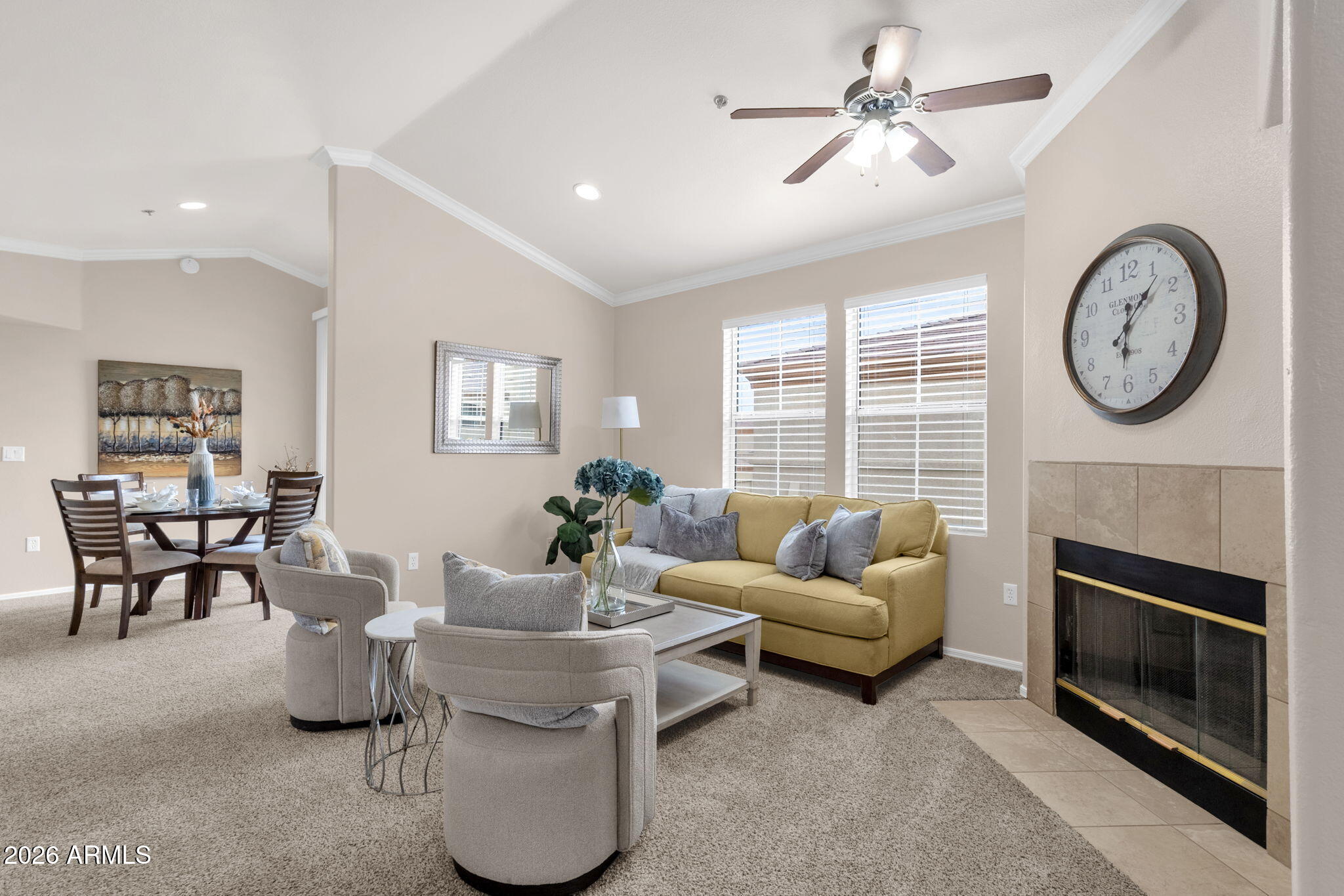 2134 East Broadway Road, Unit 2010 Tempe, AZ 85282 - Photo 3 of 42 a living room with furniture a clock and a fireplace