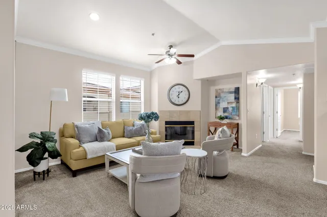 a living room with furniture a clock and a fireplace