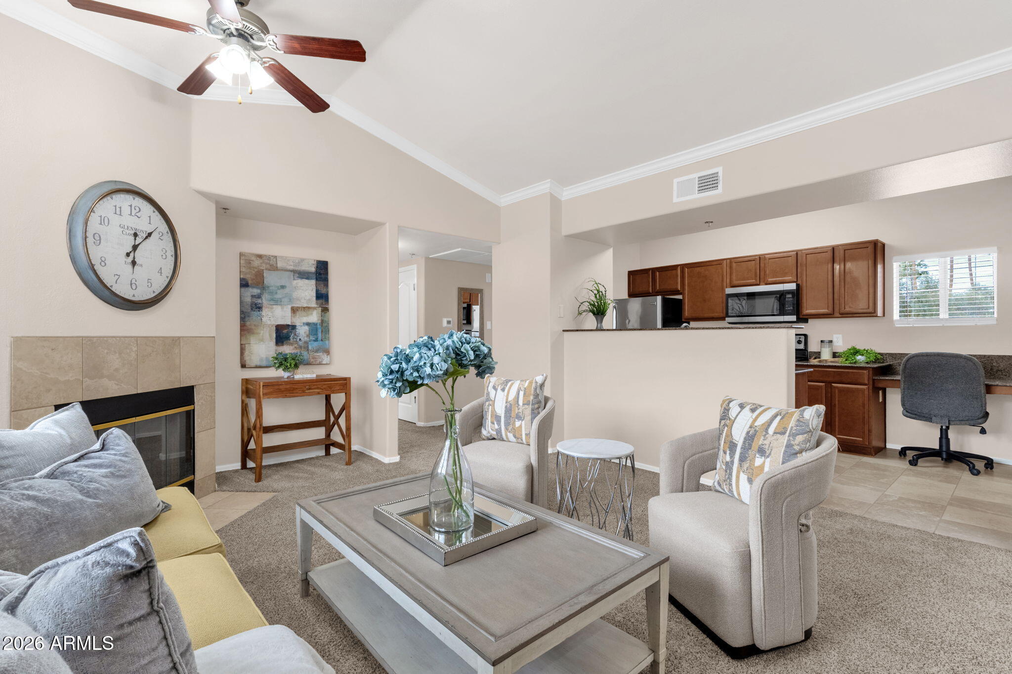 2134 East Broadway Road, Unit 2010 Tempe, AZ 85282 - Photo 5 of 42 a living room with furniture a fireplace and a ceiling fan