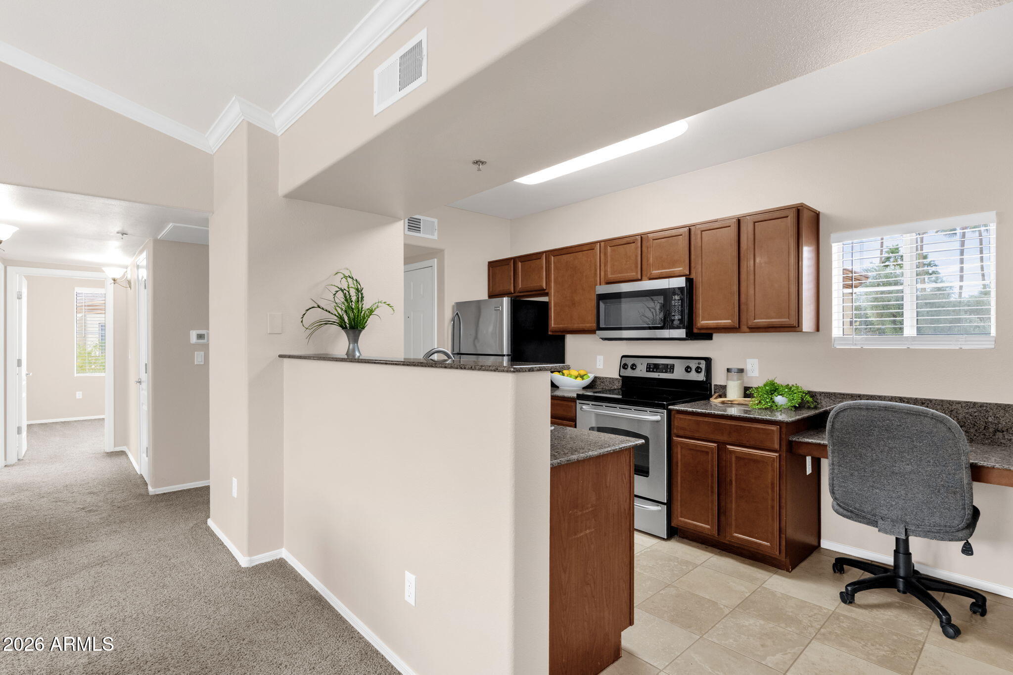 2134 East Broadway Road, Unit 2010 Tempe, AZ 85282 - Photo 6 of 42 a kitchen with kitchen island granite countertop a stove top oven a sink a dining table and chairs
