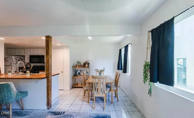 a view of a dining room with furniture and window