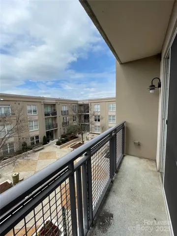 a view of balcony with two windows and couches