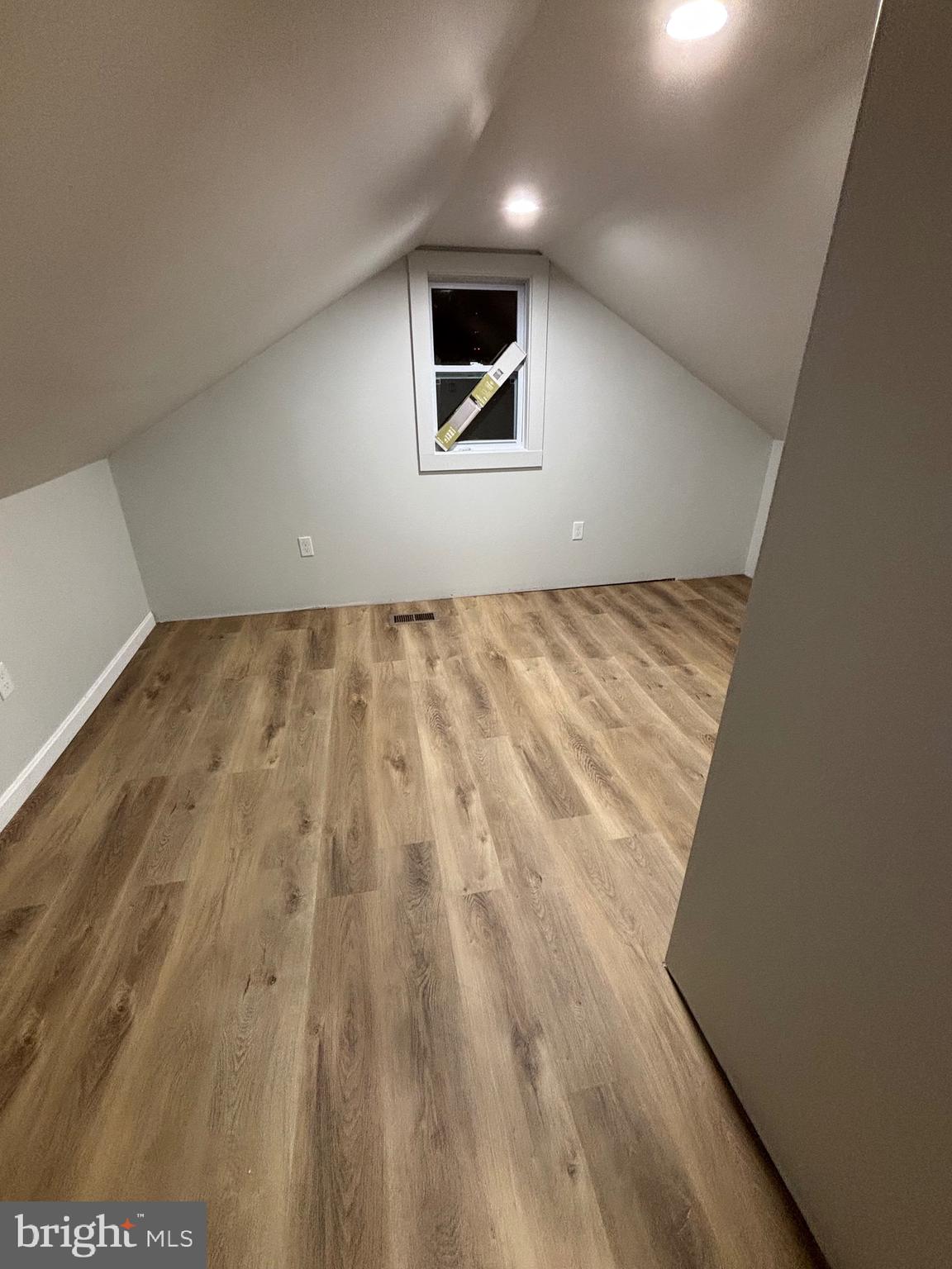 224 Pinewood Road Baltimore, MD 21222 - Photo 12 of 21 a view of an empty room with wooden floor and a window