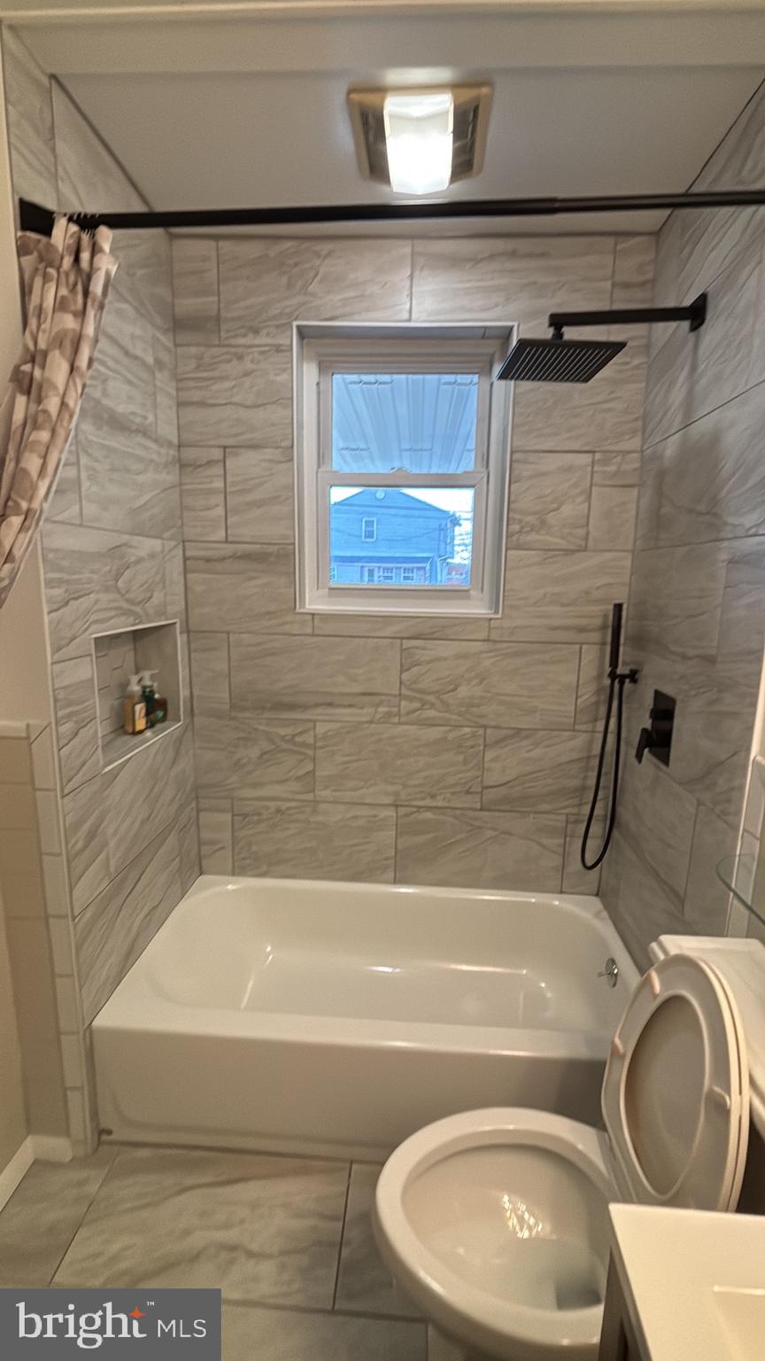 224 Pinewood Road Baltimore, MD 21222 - Photo 15 of 21 a bathroom with a sink a toilet and bathtub