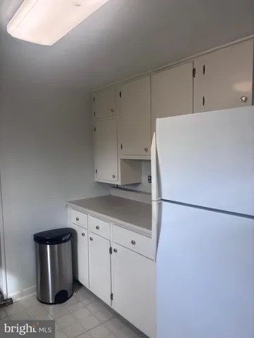 a utility room with cabinets washer and dryer