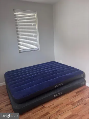 a view of a room with wooden floor and a window