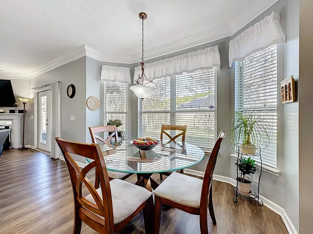 a view of a dining room with furniture wooden floor and chandelier