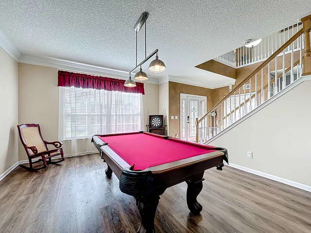 a living room with furniture a ceiling fan and a window