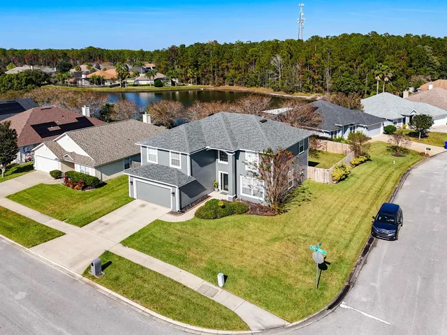 an aerial view of a house with a garden and trees