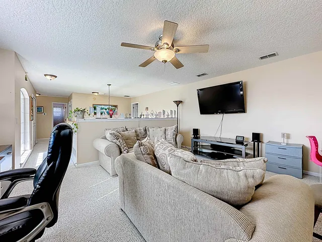 a bedroom with a bed couch and window