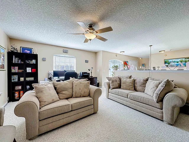 a spacious bedroom with a bed and a chandelier