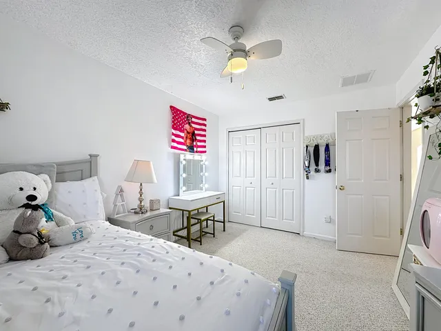 a view of a hallway with a lots of frames on wall and stairs