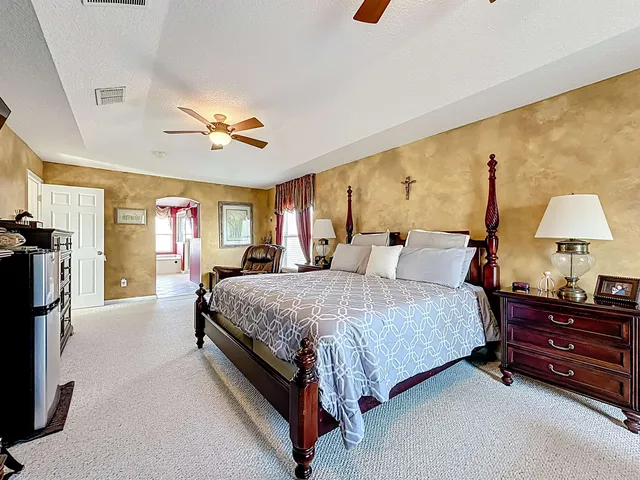 a bedroom with a large bed and a window