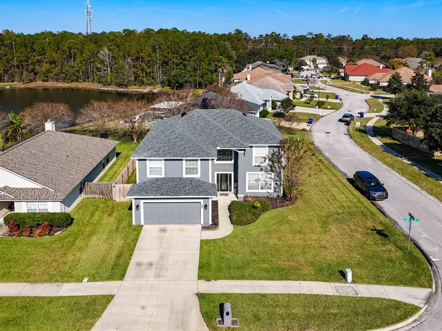 an aerial view of residential houses with outdoor space and swimming pool