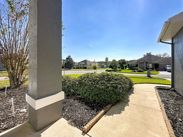 a view of a bedroom with baby bed cabinet and front door