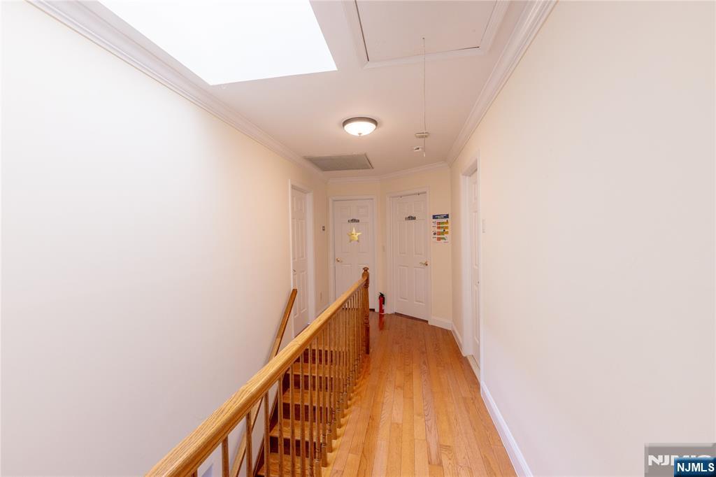 81 Crescent Avenue Mahwah, NJ 07430 - Photo 11 of 25 a view of a hallway with wooden floor and staircase