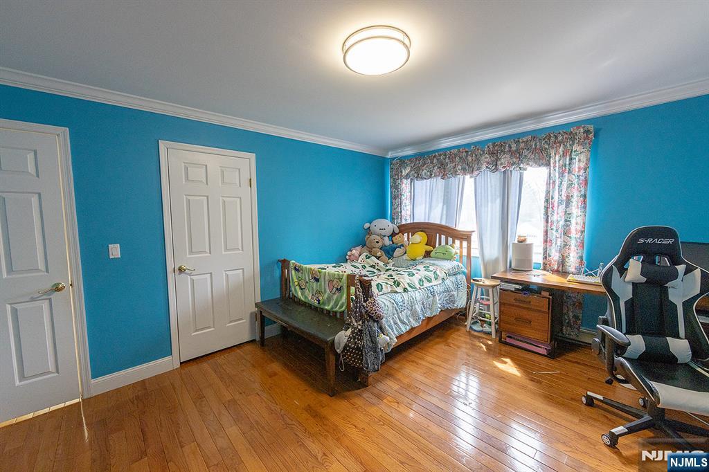 81 Crescent Avenue Mahwah, NJ 07430 - Photo 12 of 25 a bedroom with a bed and wooden floor