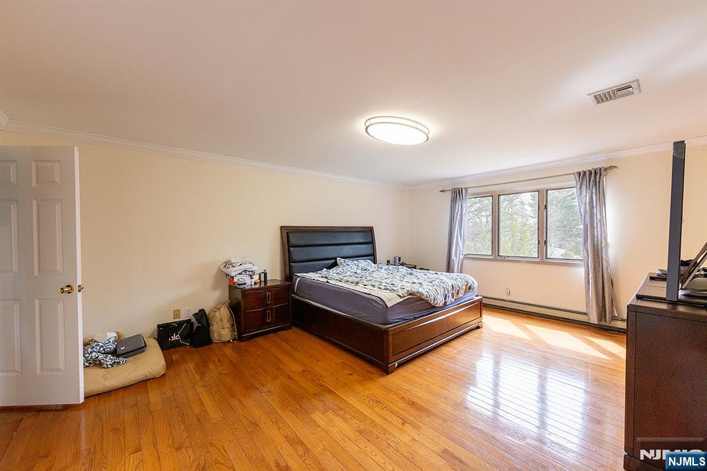 81 Crescent Avenue Mahwah, NJ 07430 - Photo 16 of 25 a bedroom with a bed and wooden floor