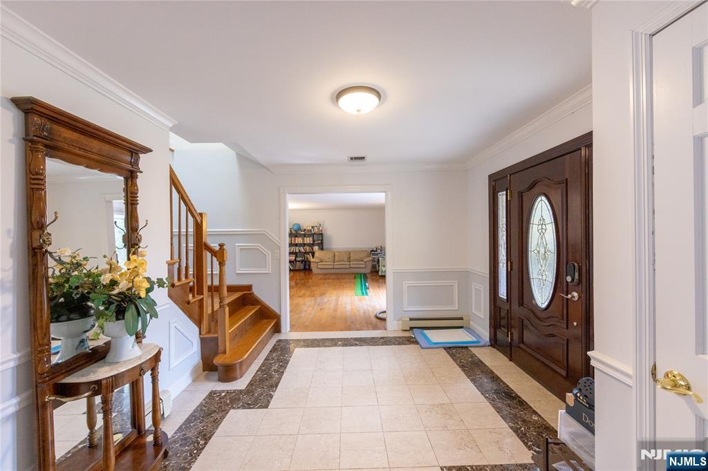 81 Crescent Avenue Mahwah, NJ 07430 - Photo 3 of 25 a living room with furniture a potted plant and a fireplace
