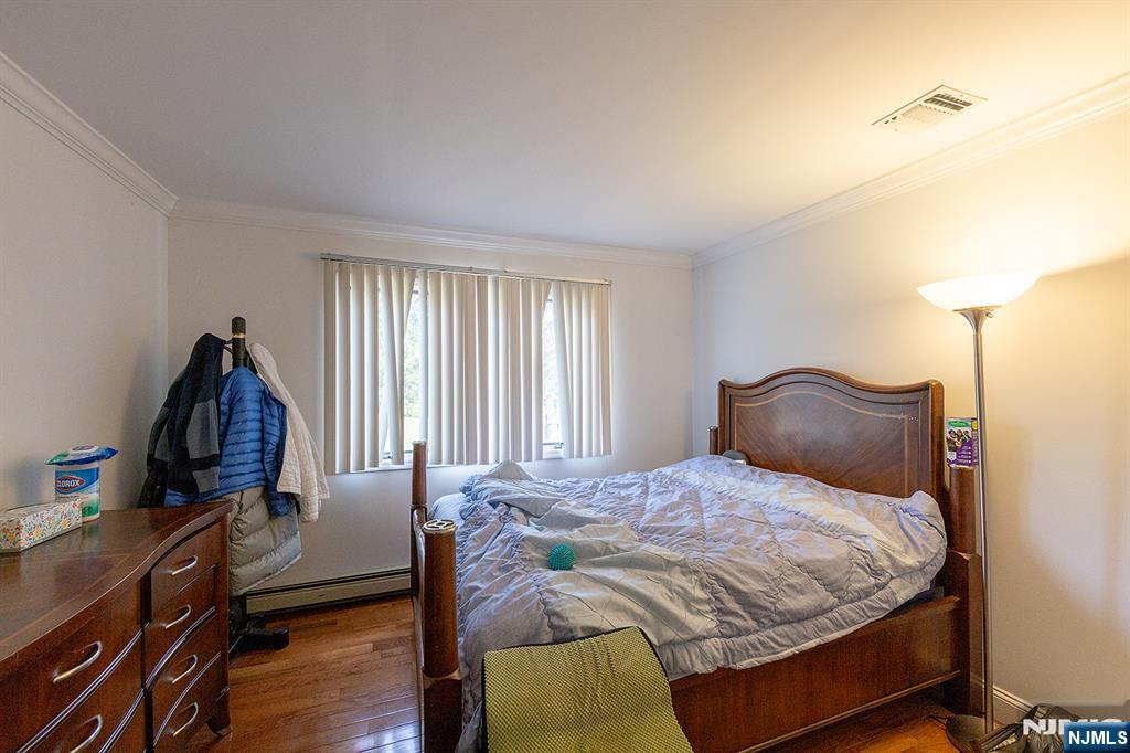 81 Crescent Avenue Mahwah, NJ 07430 - Photo 10 of 25 a bedroom with a bed and wooden floor