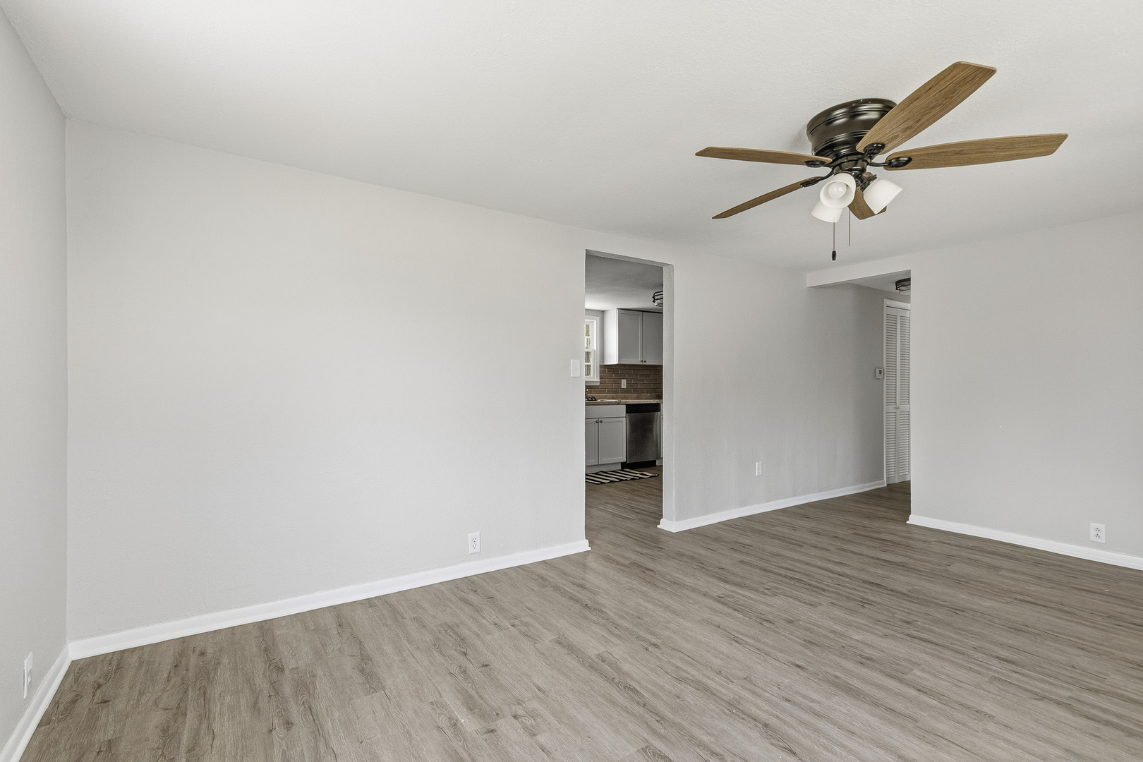 2306 9th Street Silvis, IL 61282 - Photo 10 of 32 an empty room with wooden floor and ceiling fan