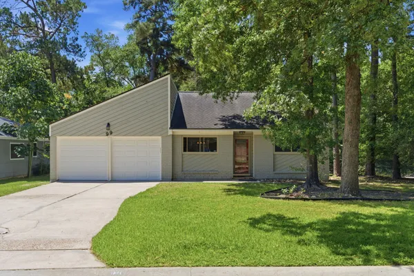 a backyard of a house with garage and trees