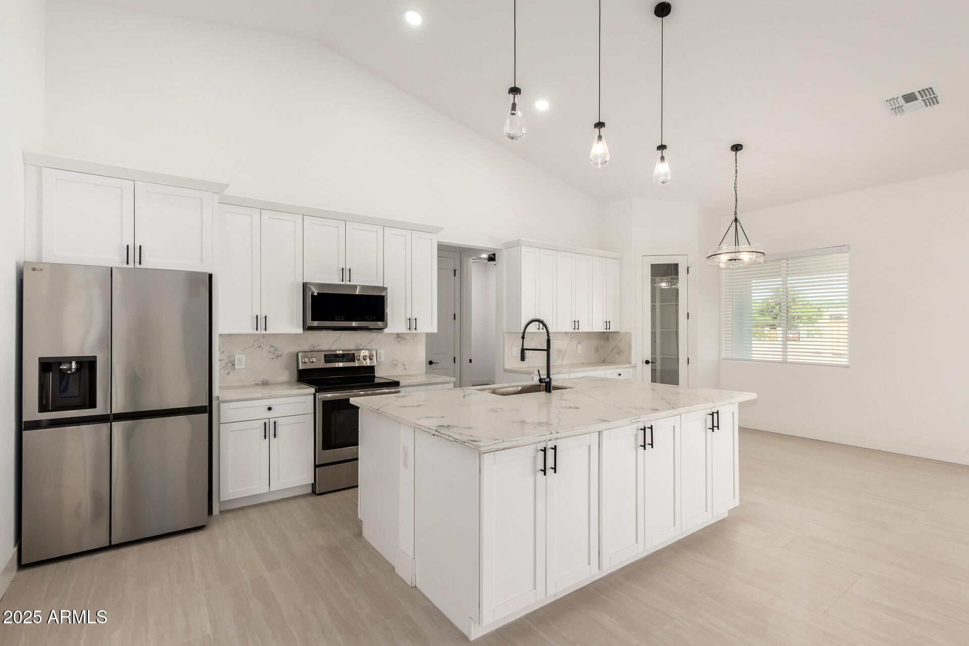 681 North Bruner Road Buckeye, AZ 85396 - Photo 19 of 60 a kitchen with stainless steel appliances granite countertop a sink a stove a refrigerator and island with wooden floor