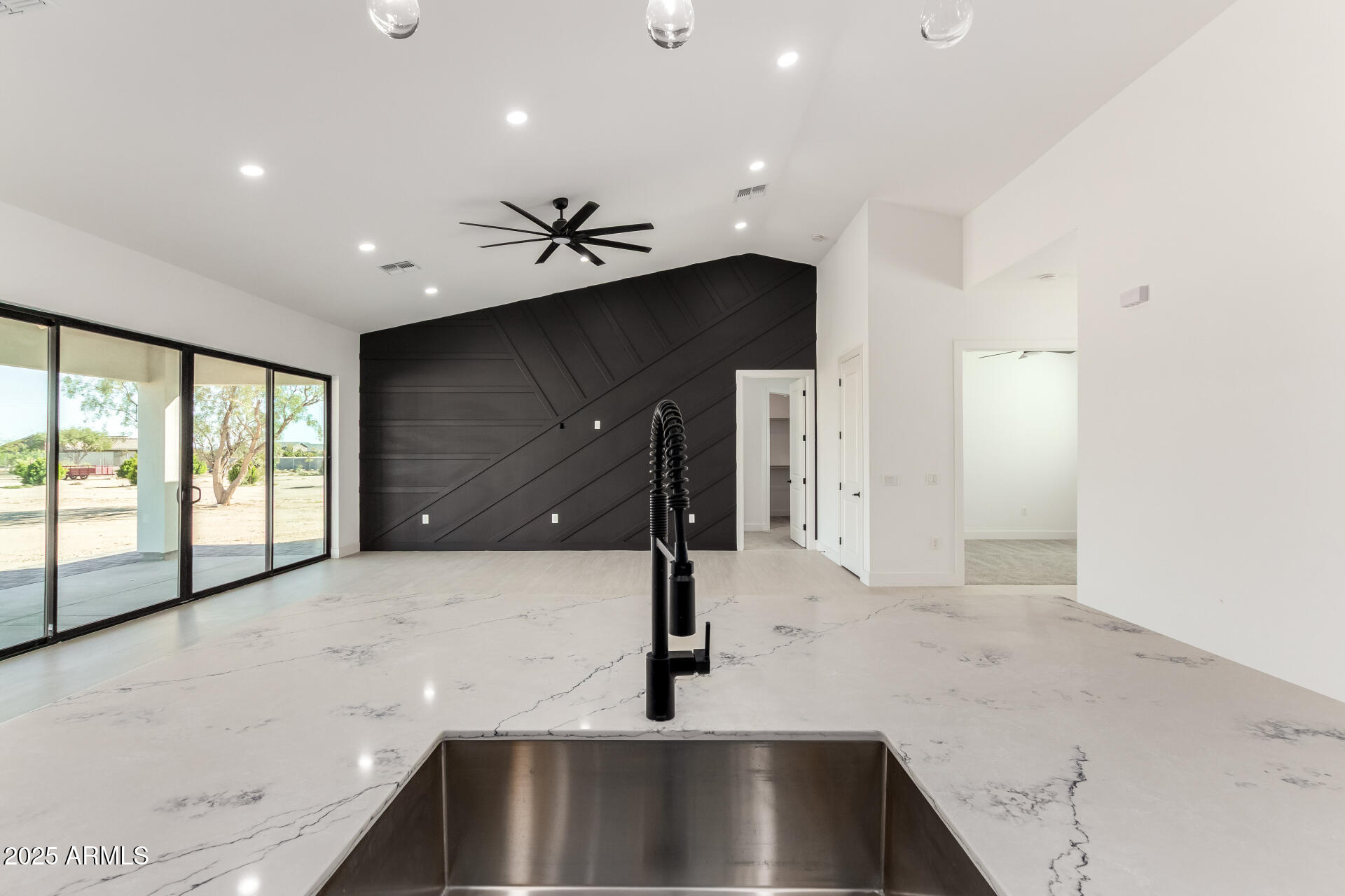 681 North Bruner Road Buckeye, AZ 85396 - Photo 20 of 60 a kitchen with kitchen island a sink stainless steel appliances and cabinets