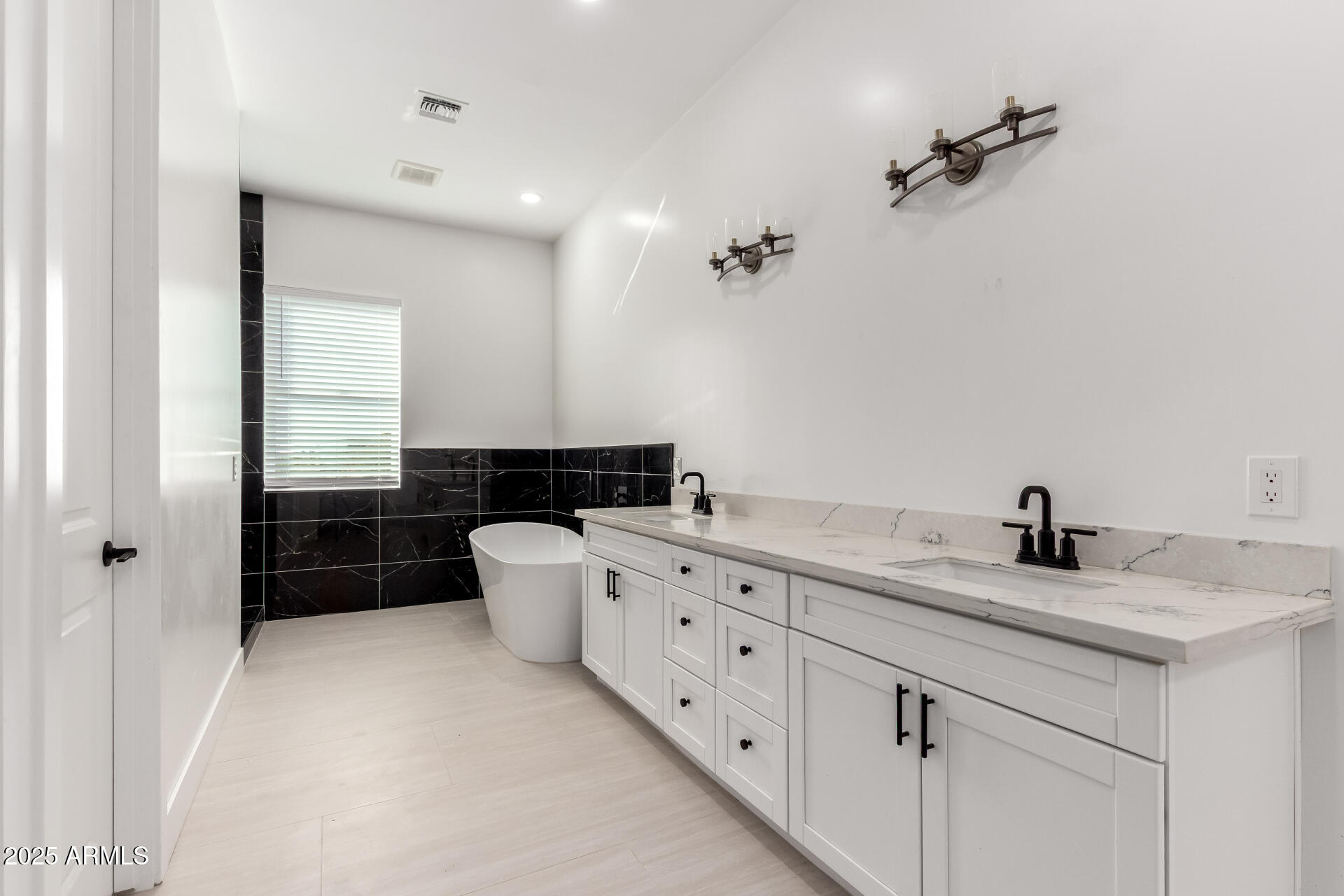681 North Bruner Road Buckeye, AZ 85396 - Photo 24 of 60 a bathroom with a double vanity sink and mirror