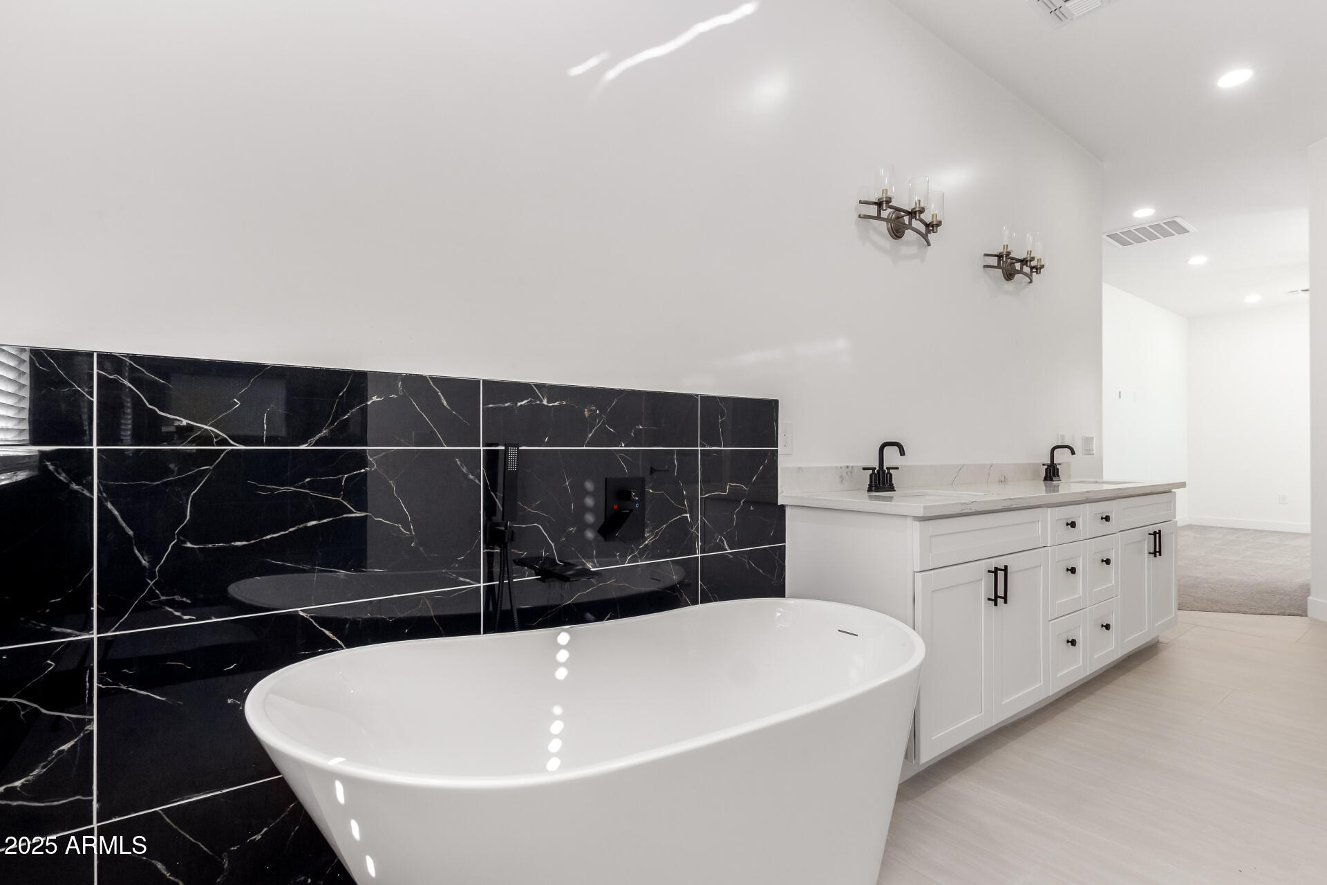 681 North Bruner Road Buckeye, AZ 85396 - Photo 25 of 60 a bathroom with a bathtub and double vanity