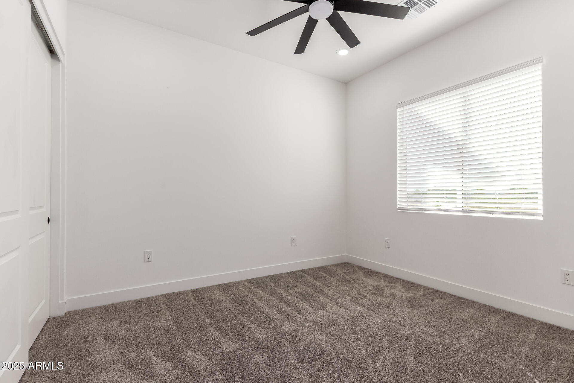 681 North Bruner Road Buckeye, AZ 85396 - Photo 28 of 60 an empty room with a window and a fan
