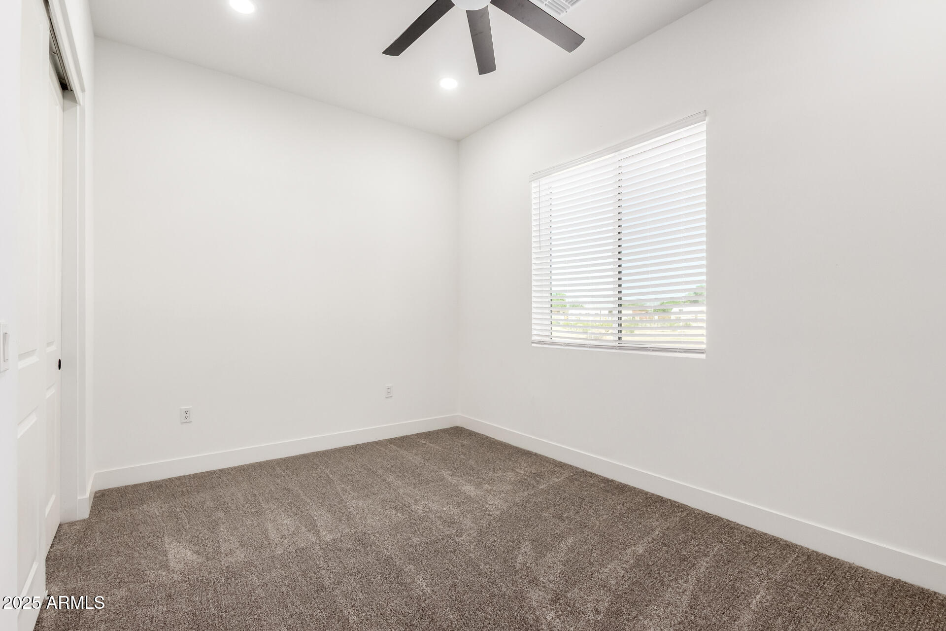 681 North Bruner Road Buckeye, AZ 85396 - Photo 30 of 60 an empty room with a window and a ceiling fan