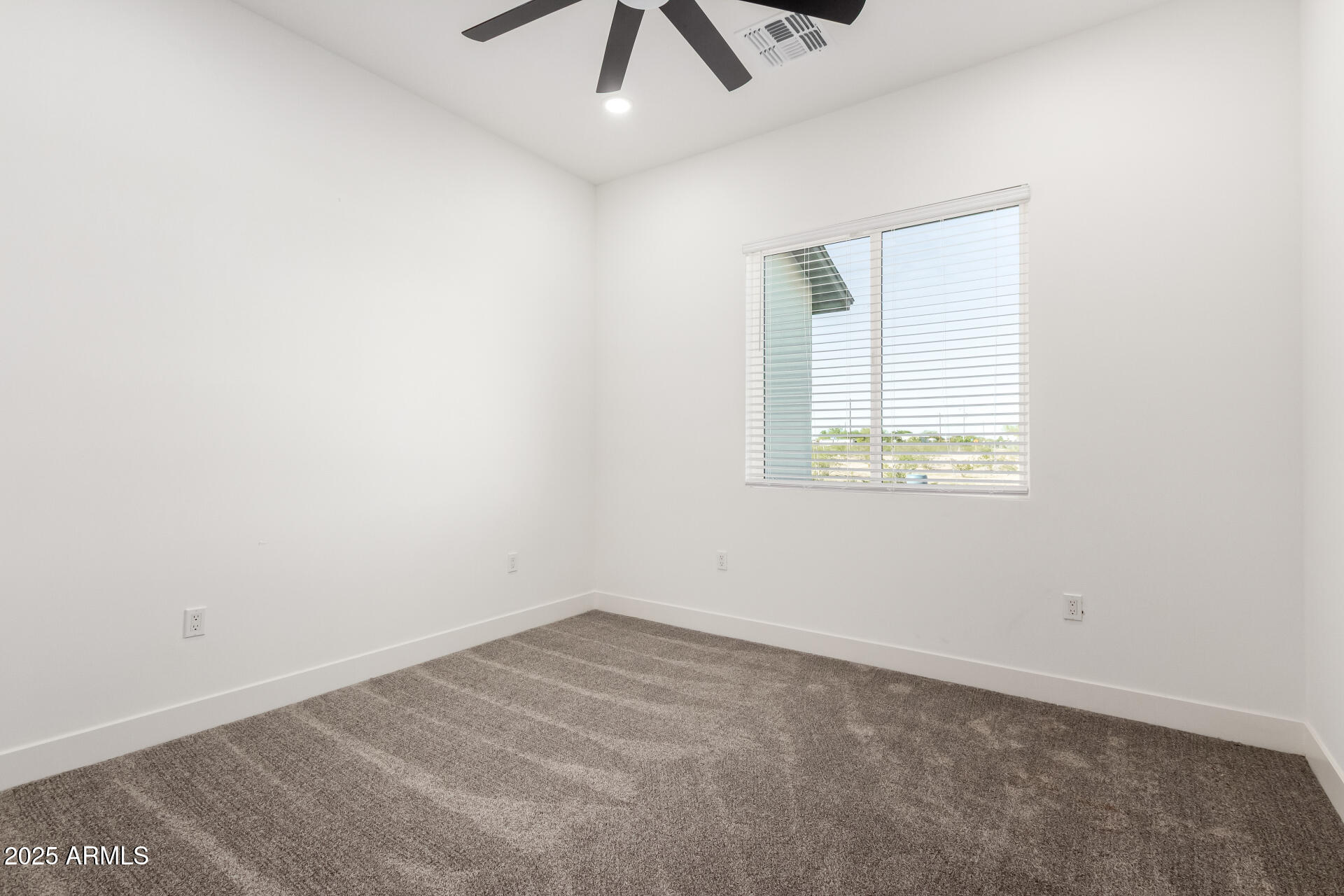 681 North Bruner Road Buckeye, AZ 85396 - Photo 32 of 60 an empty room with a window and a fan