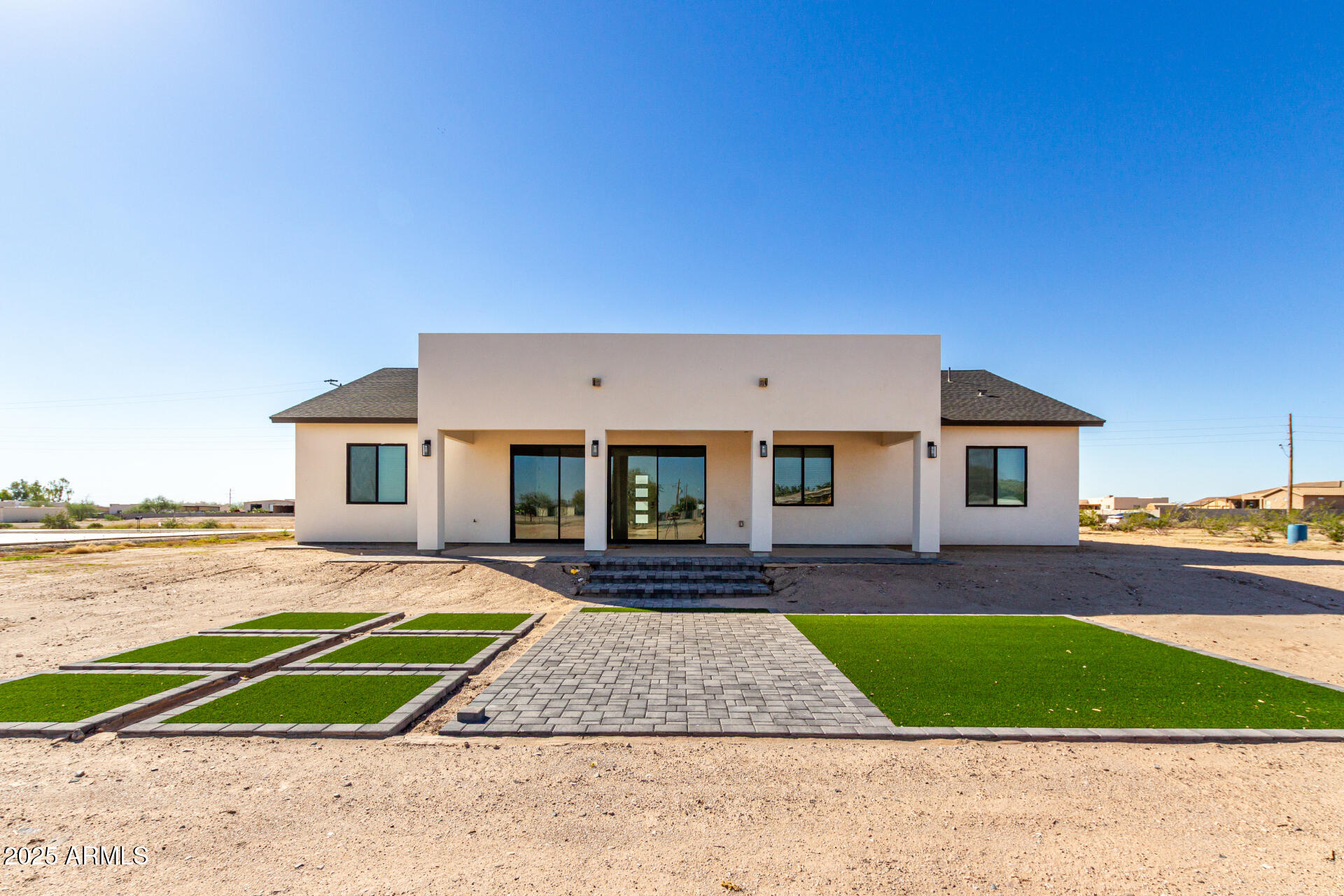 681 North Bruner Road Buckeye, AZ 85396 - Photo 40 of 60 a front view of a house with a yard and garage