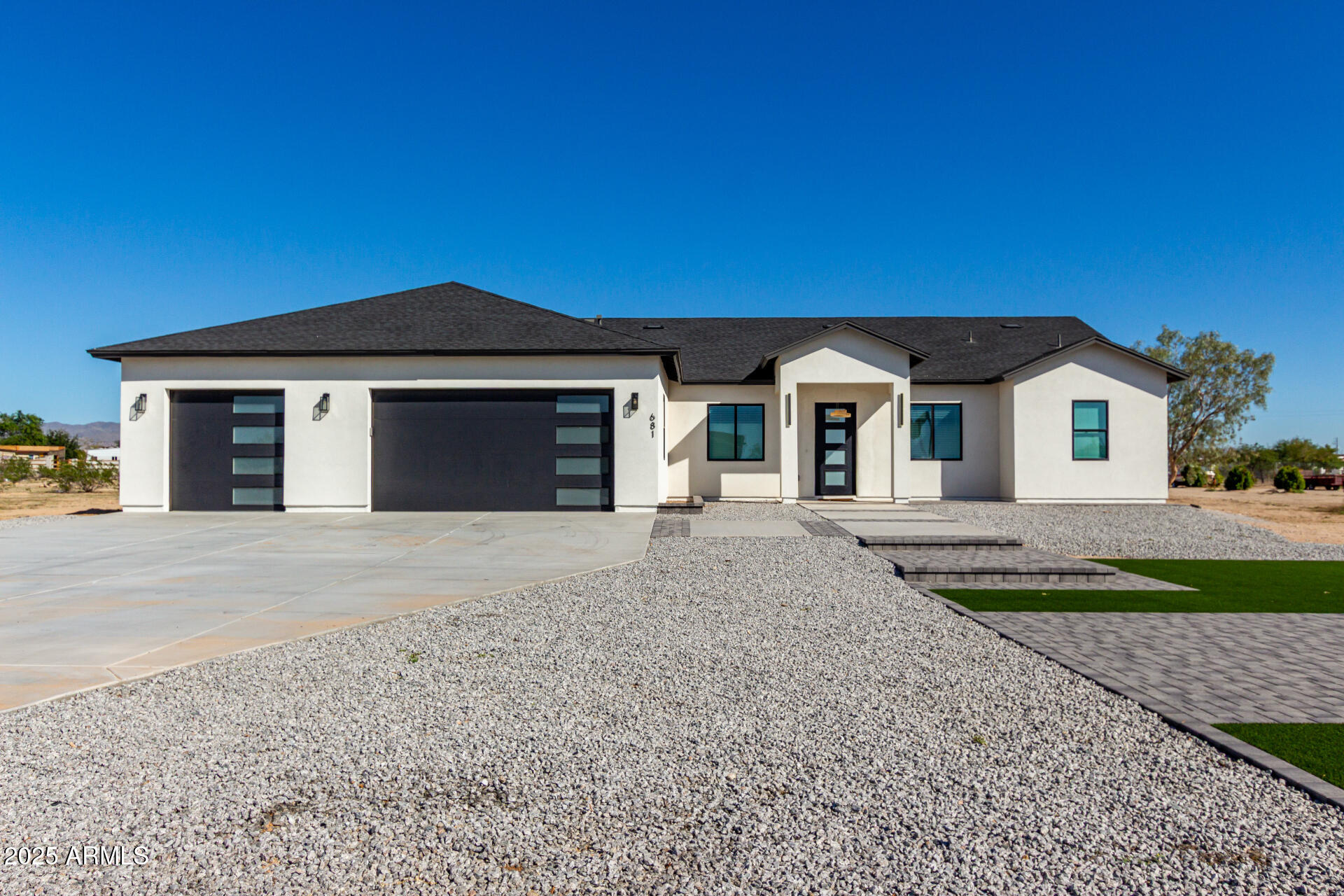 681 North Bruner Road Buckeye, AZ 85396 - Photo 4 of 60 a front view of a house with a yard and garage