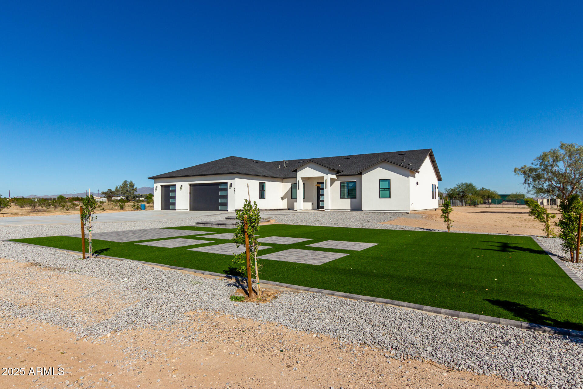 681 North Bruner Road Buckeye, AZ 85396 - Photo 5 of 60 a front view of a house with a yard and garage