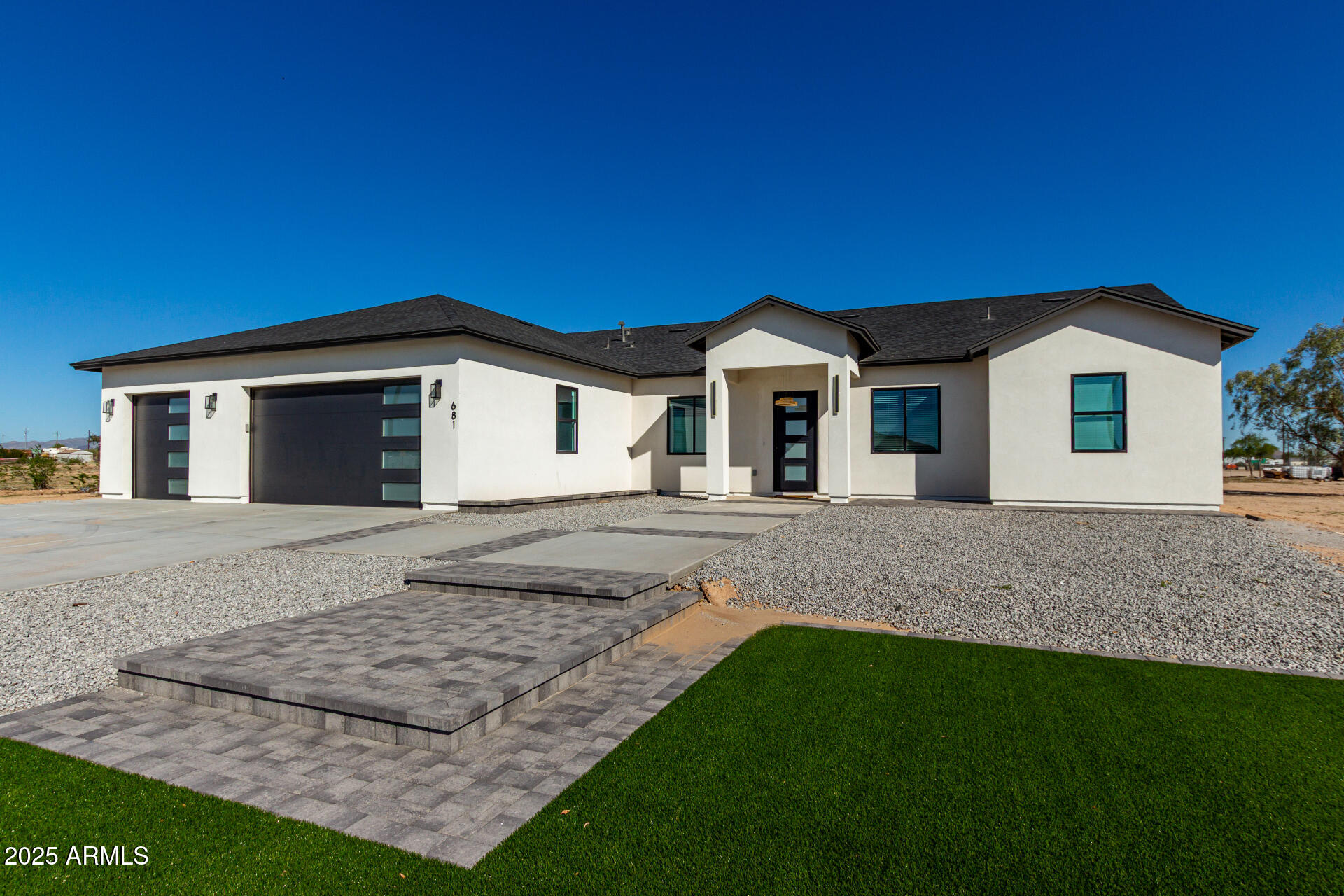 681 North Bruner Road Buckeye, AZ 85396 - Photo 6 of 60 a front view of a house with a garden