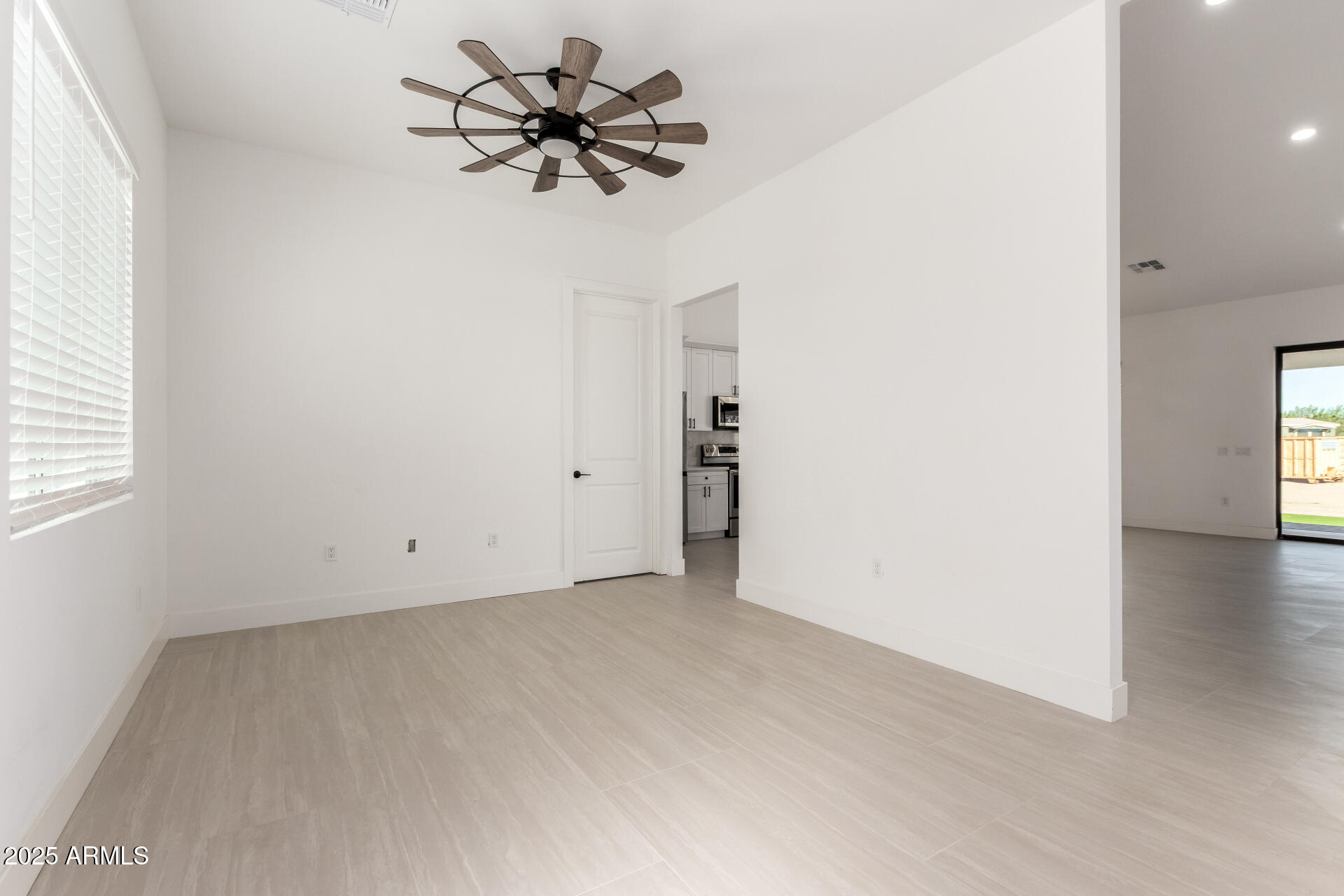 681 North Bruner Road Buckeye, AZ 85396 - Photo 10 of 60 an empty room with a window and a ceiling fan