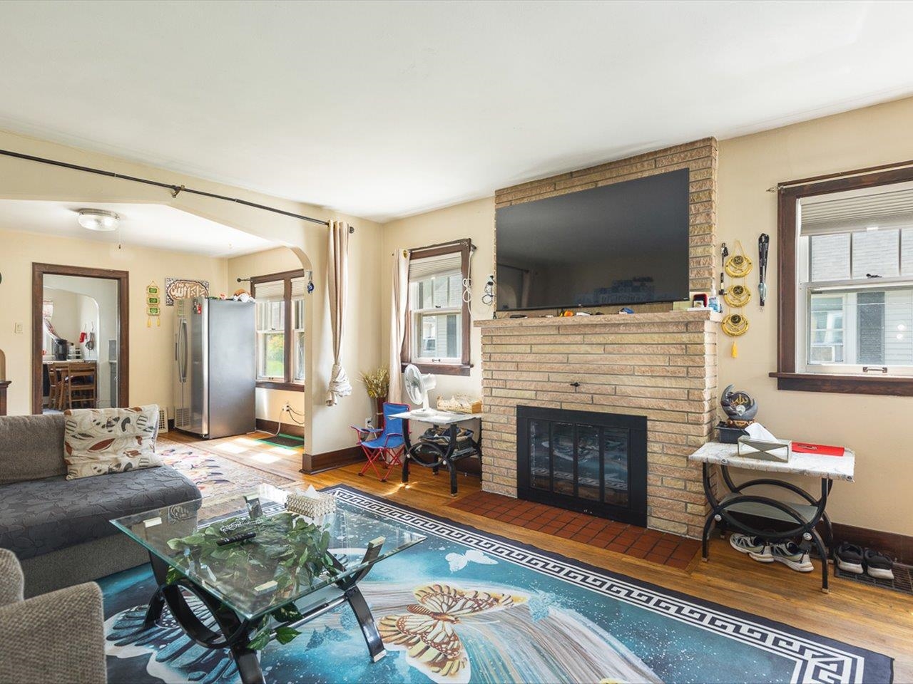 1247 West Logan Street Freeport, IL 61032 - Photo 6 of 34 a living room with furniture a flat screen tv and a fireplace