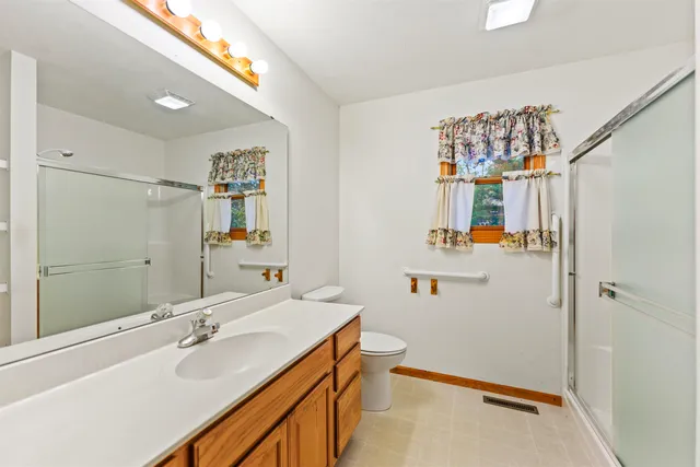 a bathroom with a sink double vanity and a mirror
