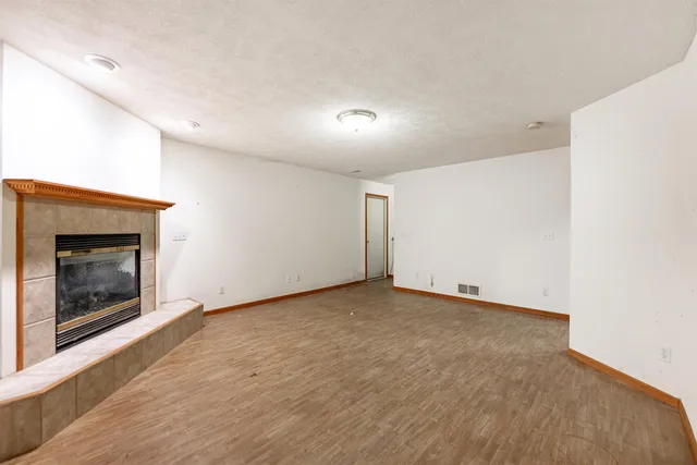 a view of an empty room with a fireplace